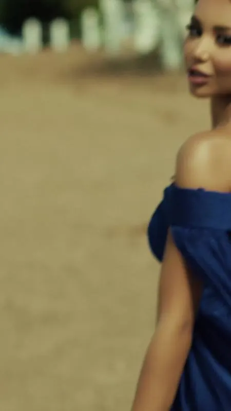 Dancer in a blue off-shoulder gown on sand