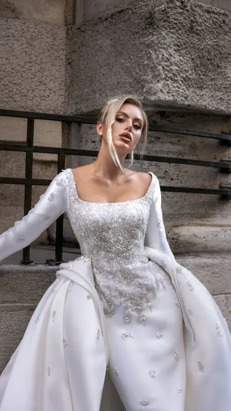 Satin bridal gown against stone walls