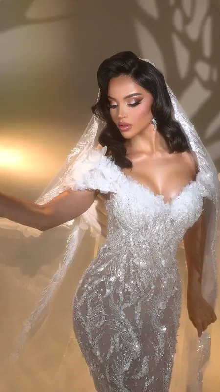 Bride in a beaded gown with a veil in warm light