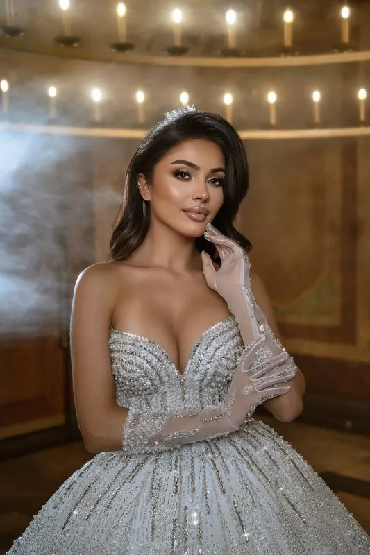 Bride under a candle chandelier with haze