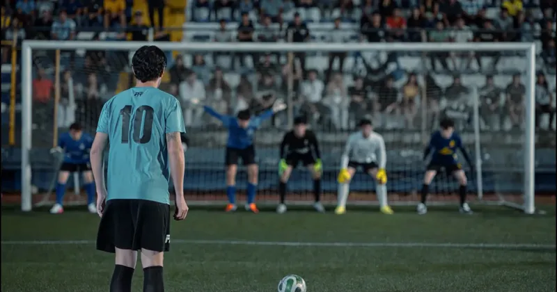The striker in number 10 facing six goalkeepers in the stadium