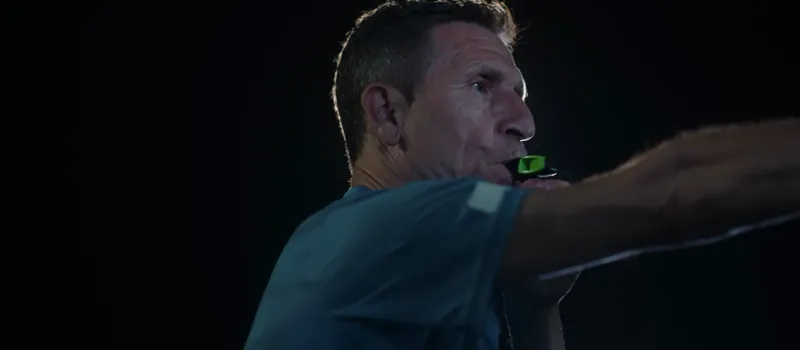 The referee blowing the whistle