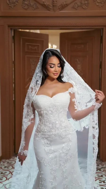 Bride in lace with a long veil by carved doors
