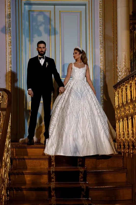 Couple on a palace staircase in front of tall doors