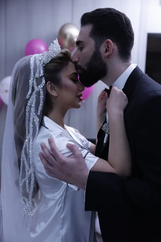 The couple kissing under the veil