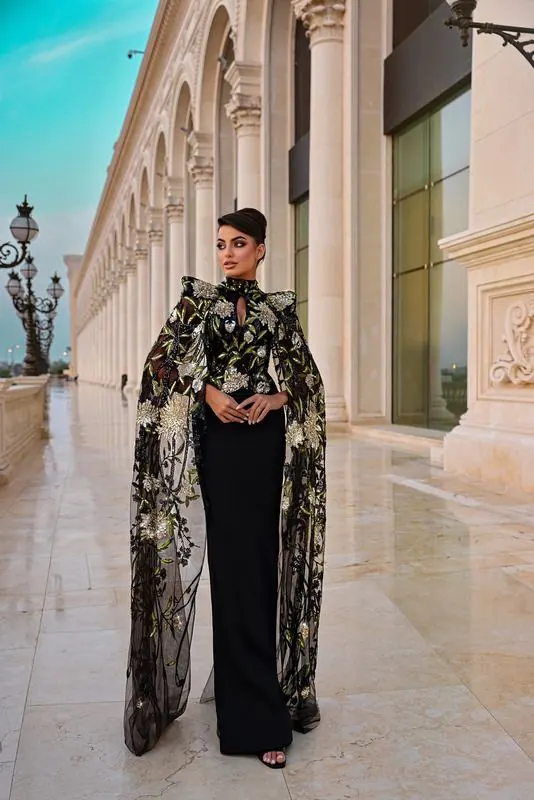 Black cape gown in an arcade
