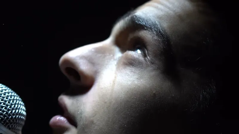 Profile at the microphone in the dark