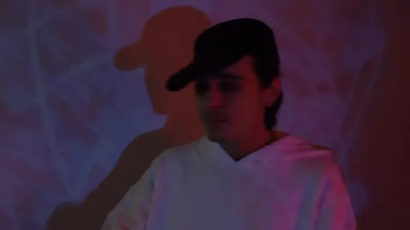 Singer in a cap against projected light