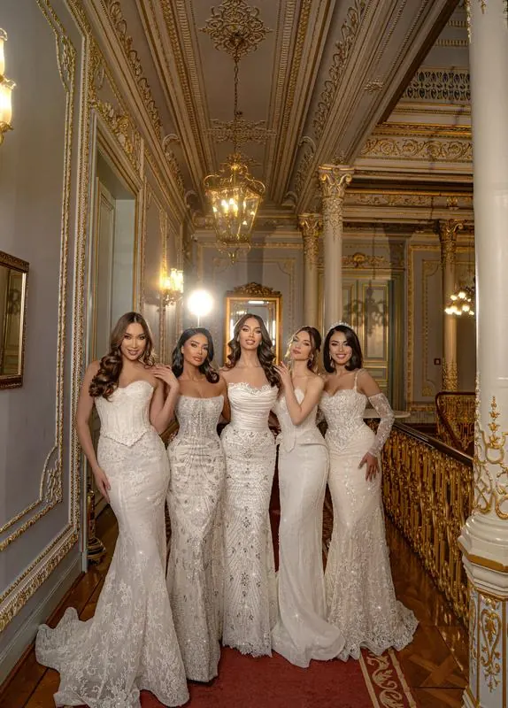 Five brides under a chandelier