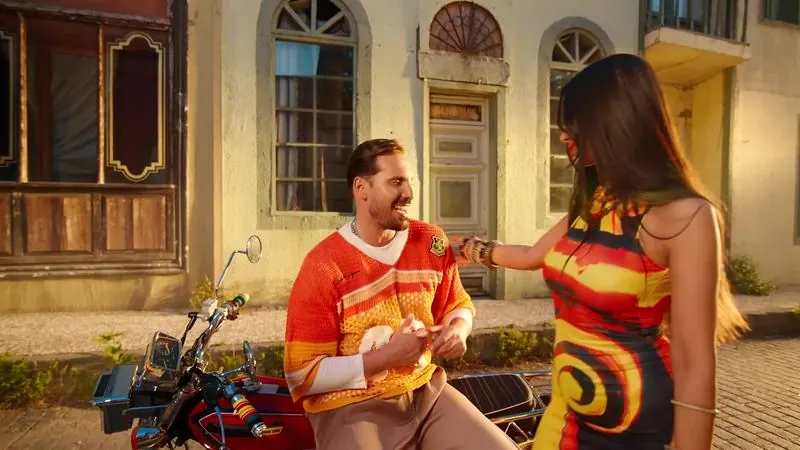 Aziz Abdo on a motorbike with a dancer
