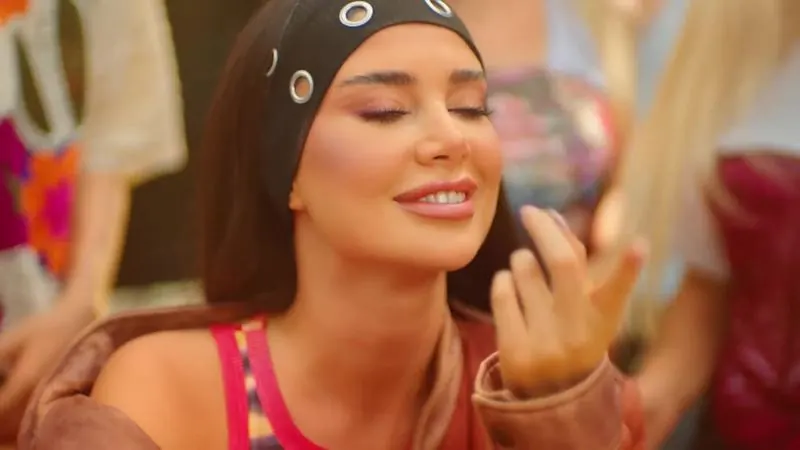 Dancer in a bandana, eyes closed, smiling